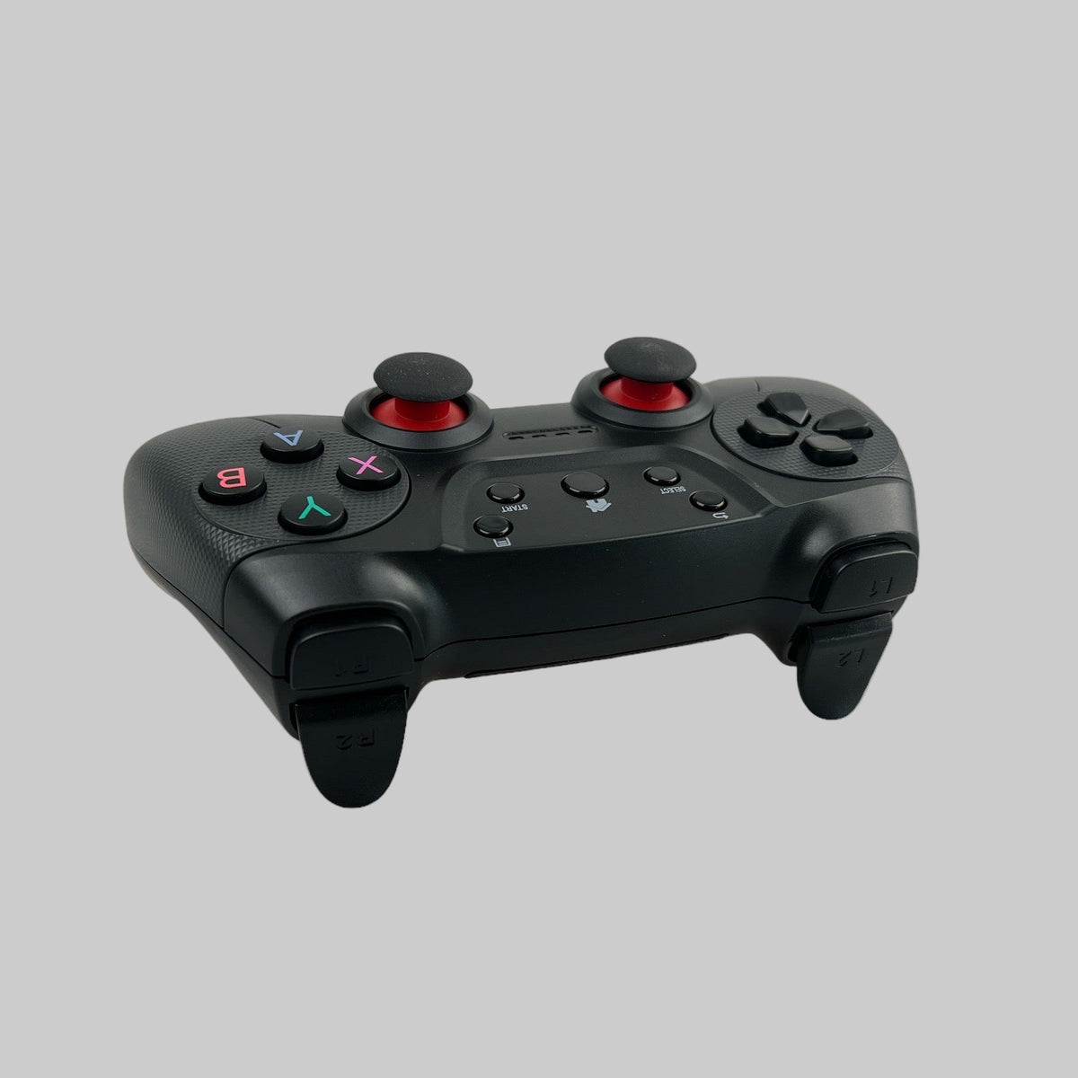Trådløs controller set bagfra. Farven er sort, og har lidt rødt. Kan bruges i Tesla biler.