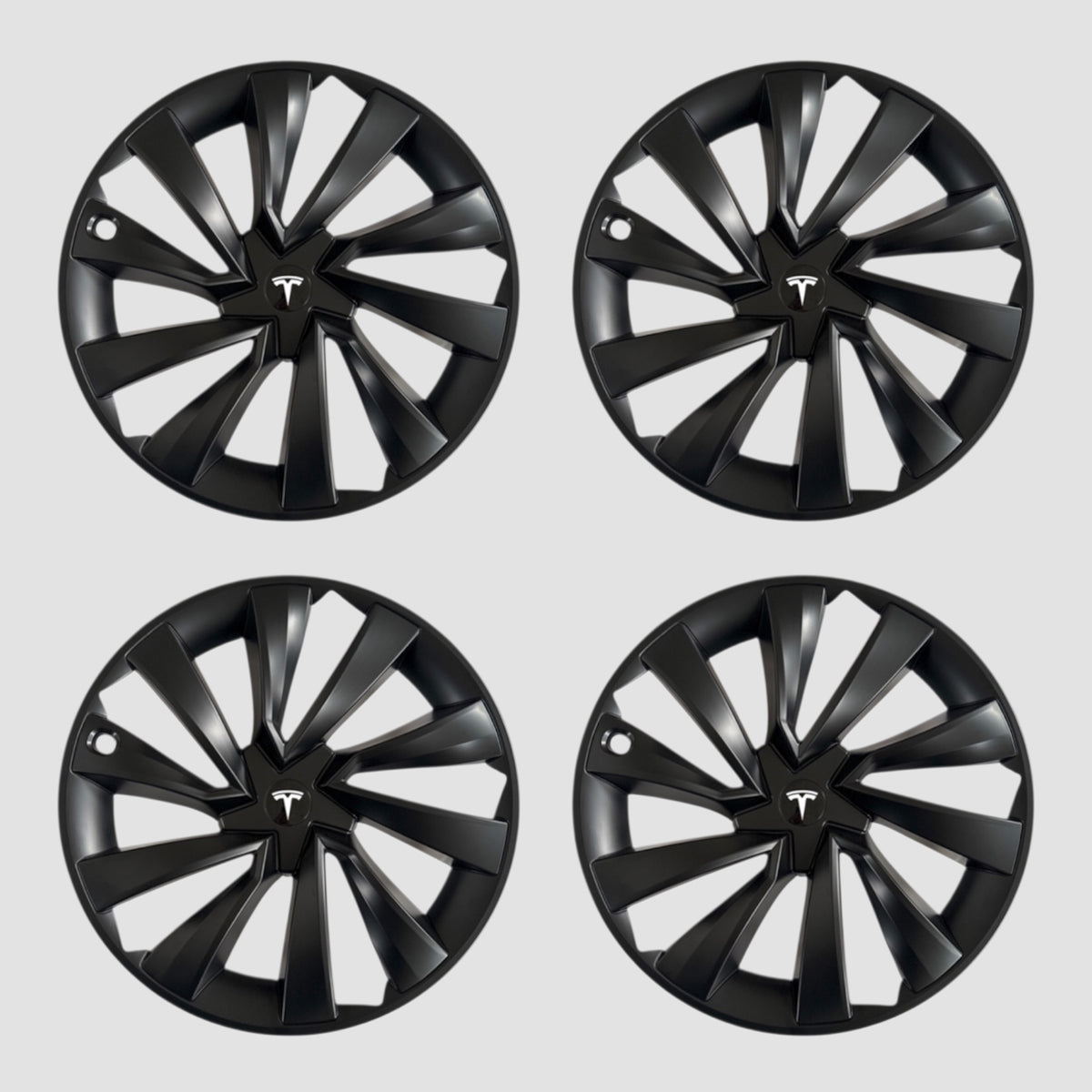 Fire sorte MV Spiral hjulkapsler med Tesla logo til Model Y 2025.